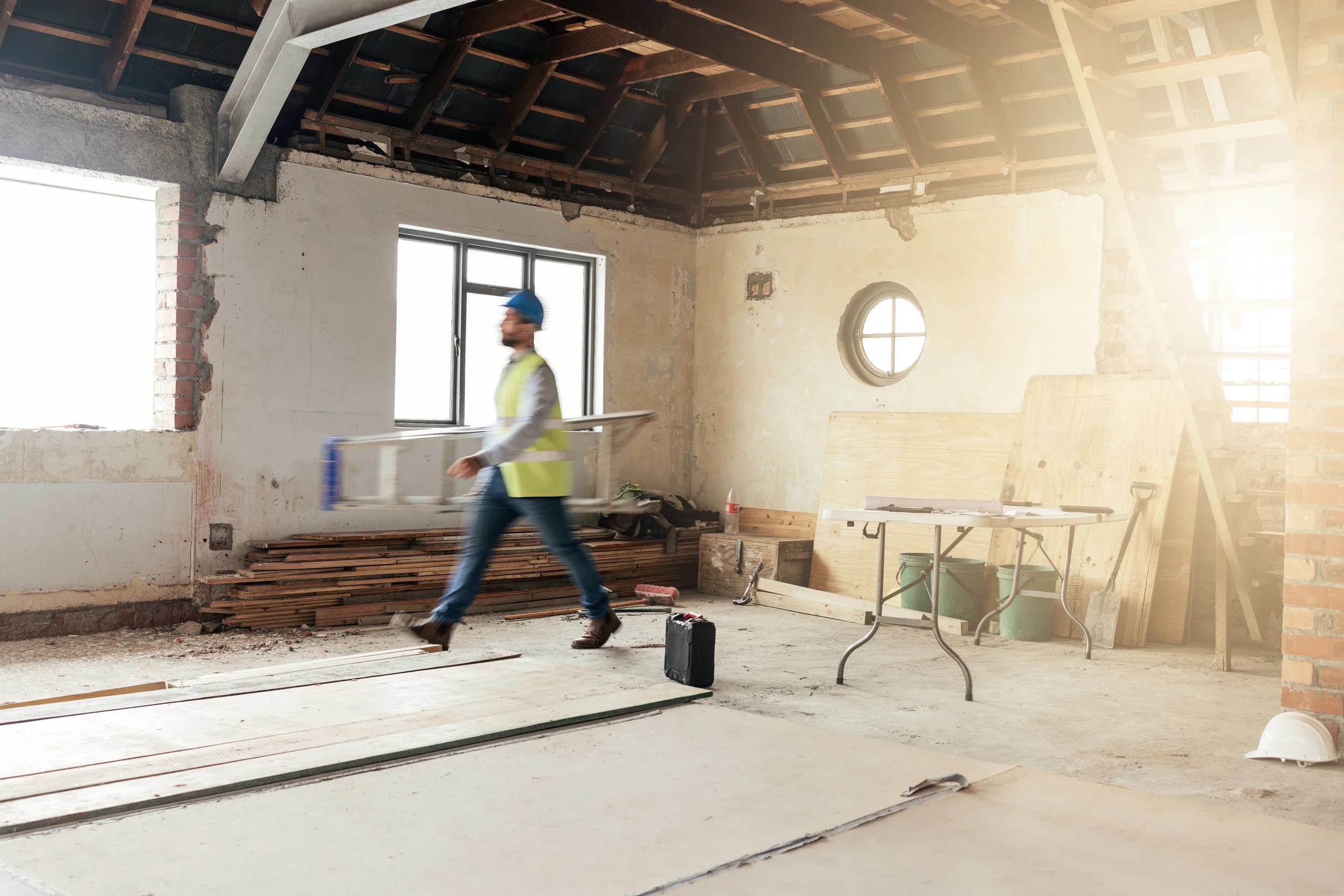 Installer moving flooring planks through a unit renovation